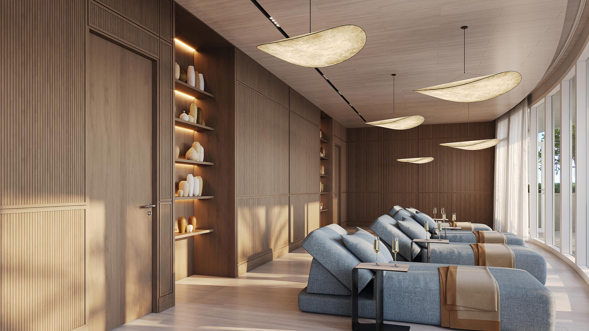 Tranquil spa lounge with light blue recliners, tan blankets, large windows, wood paneling, minimalist shelves, leaf pendant lights