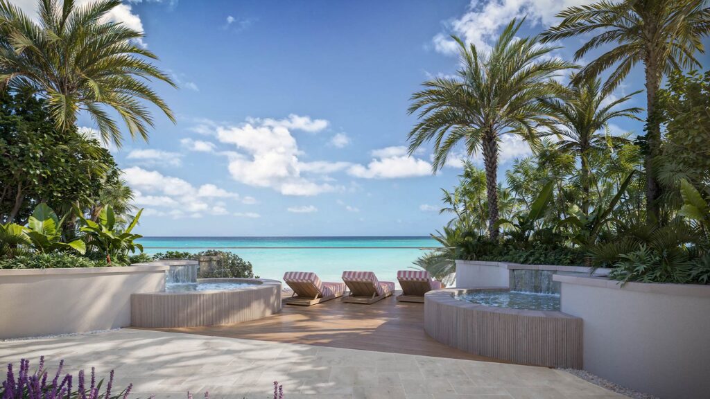 Viceroy Residences Clearwater Beach luxury terrace with striped loungers, palms, water features, turquoise ocean under blue sky
